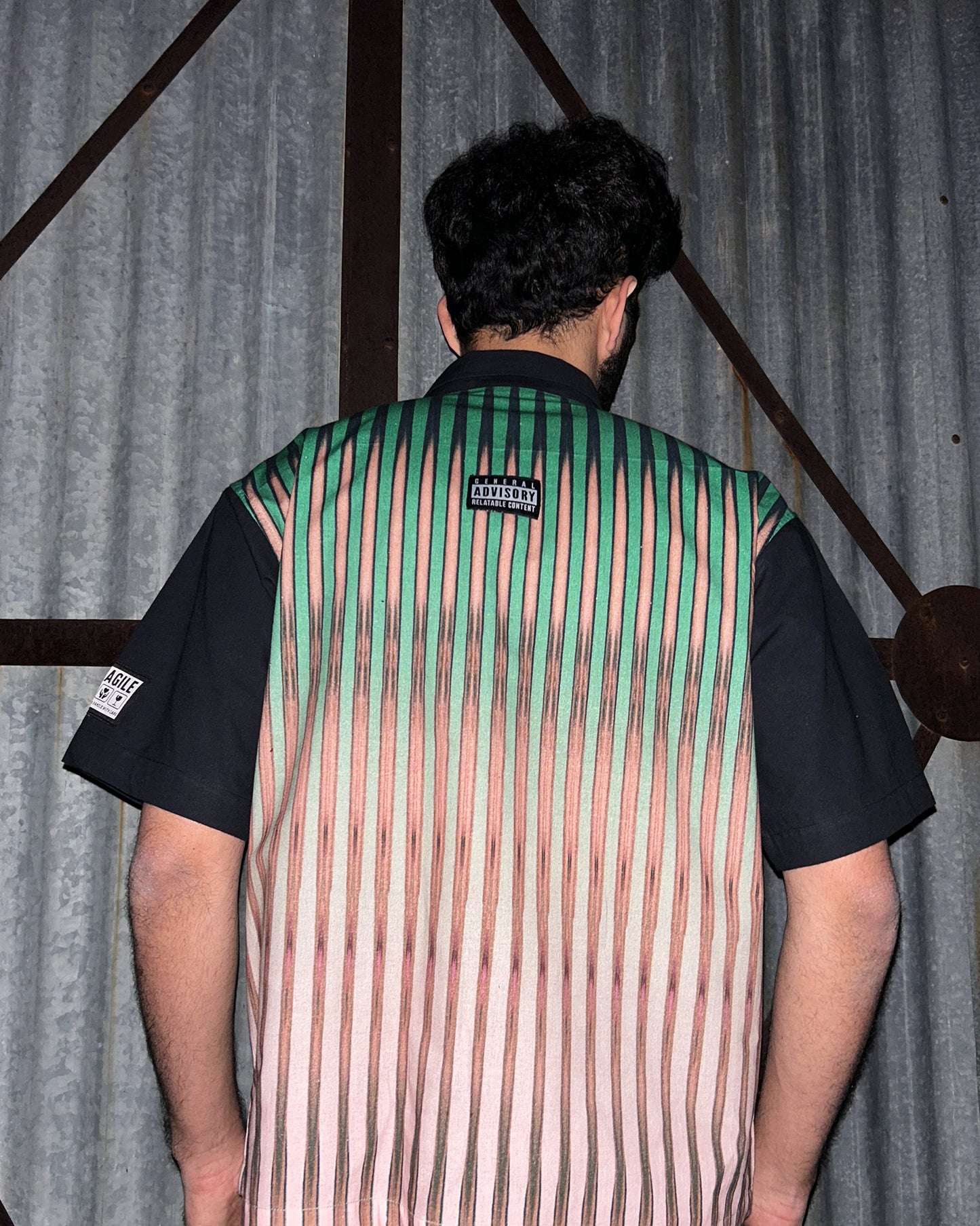 Back View of model wearing Between the Lines Green Shirt