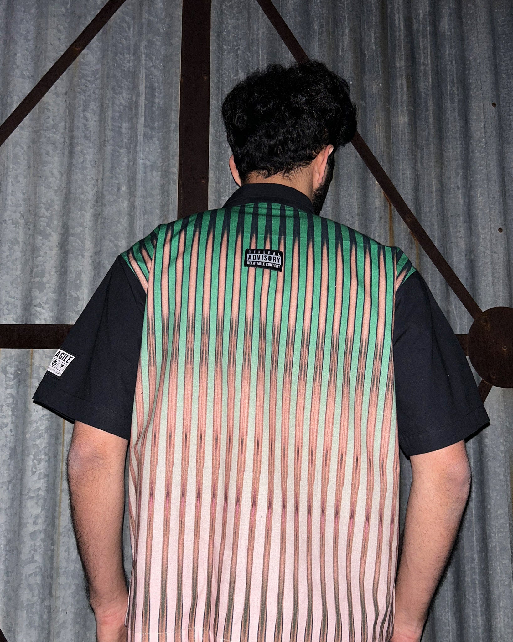 Back View of model wearing Between the Lines Green Shirt
