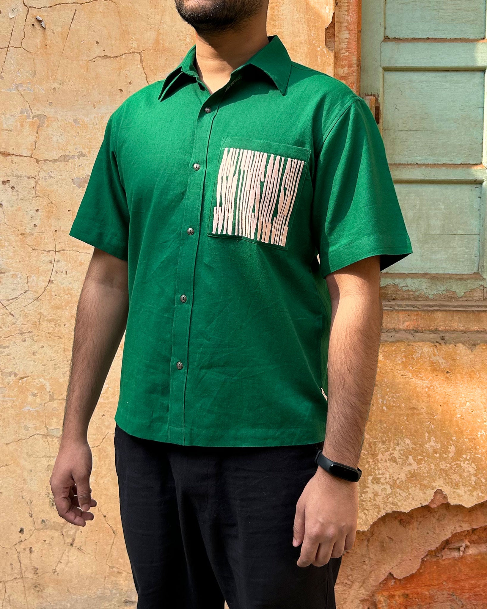 Model wearing Silent Scream Green Shirt with Pink Embroidered Message