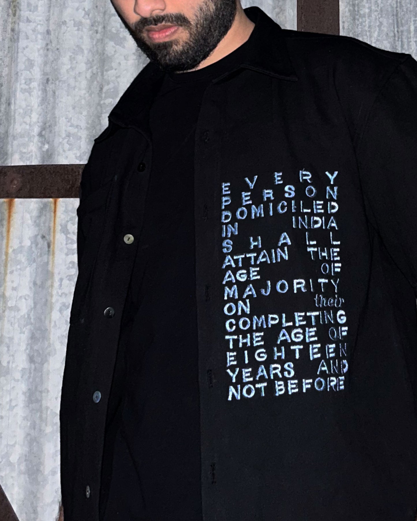 Model wearing Majority Act Black Shirt with Embroidered Text